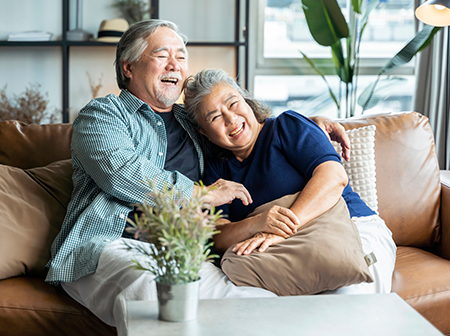 Older couple sitting together on a couch